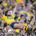 A Michigan fan is tossed in the air as fans celebrate a touchdown  against Air Force during the first quarter at Michigan Stadium on Saturday. Melanie Maxwell I AnnArbor.com